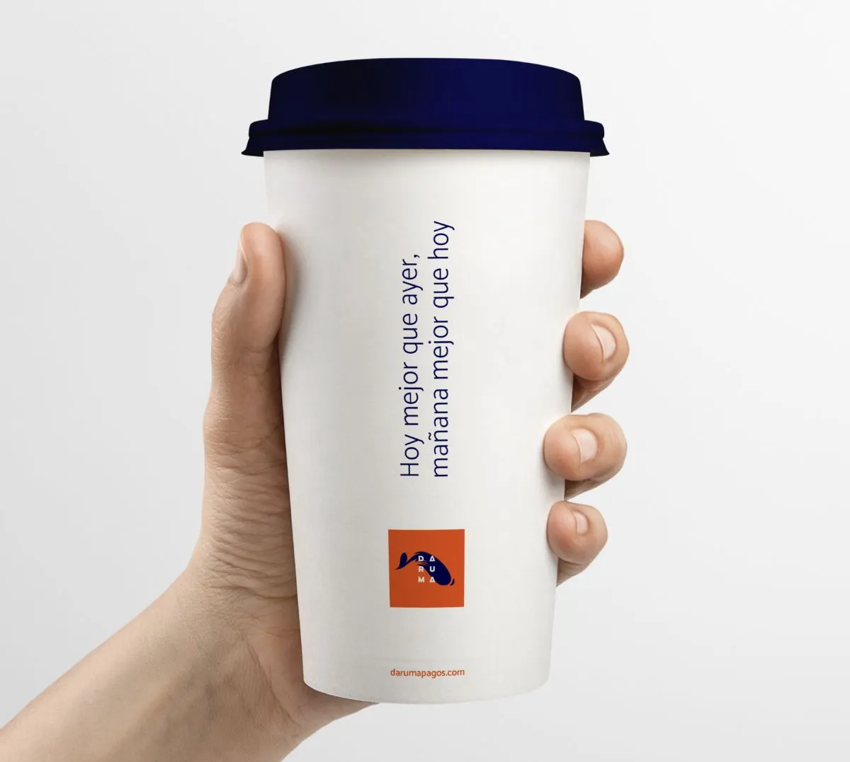 Hand holding a takeaway cup printed with the brand