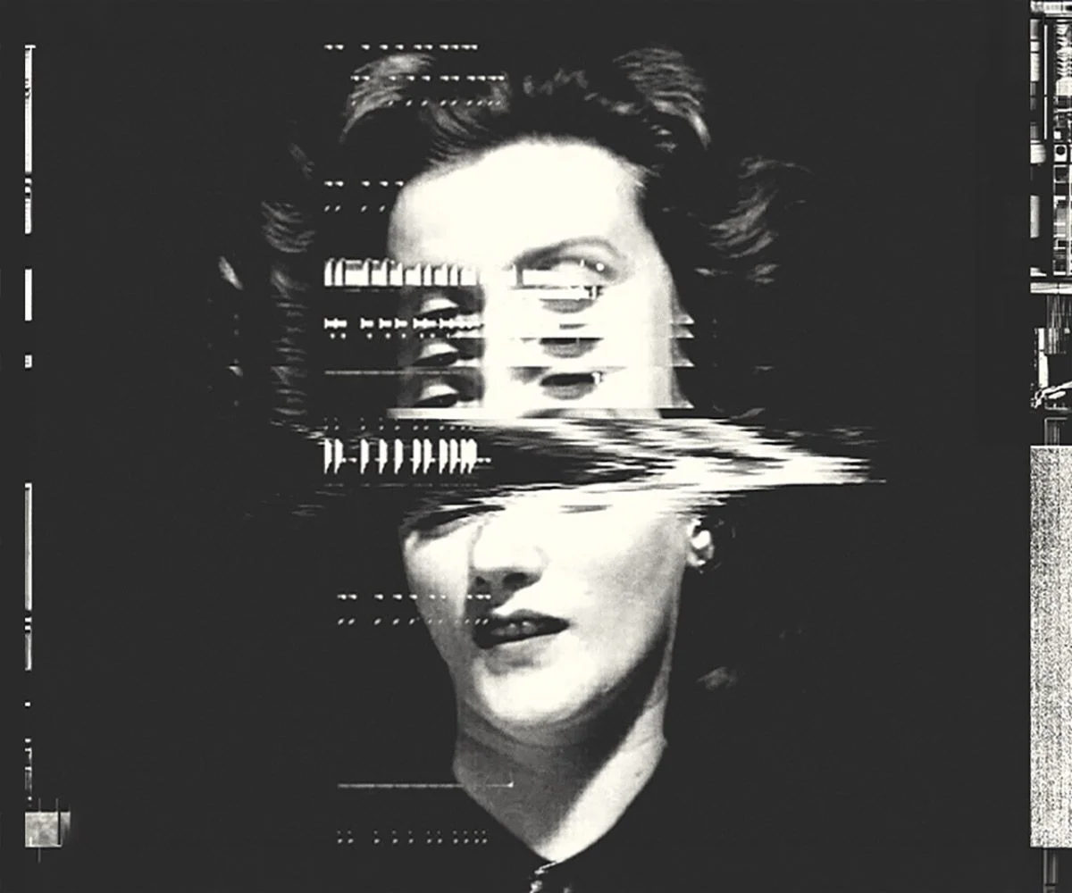 Black and white portrait of a woman broken by horizontal glitch bands that displace her features.