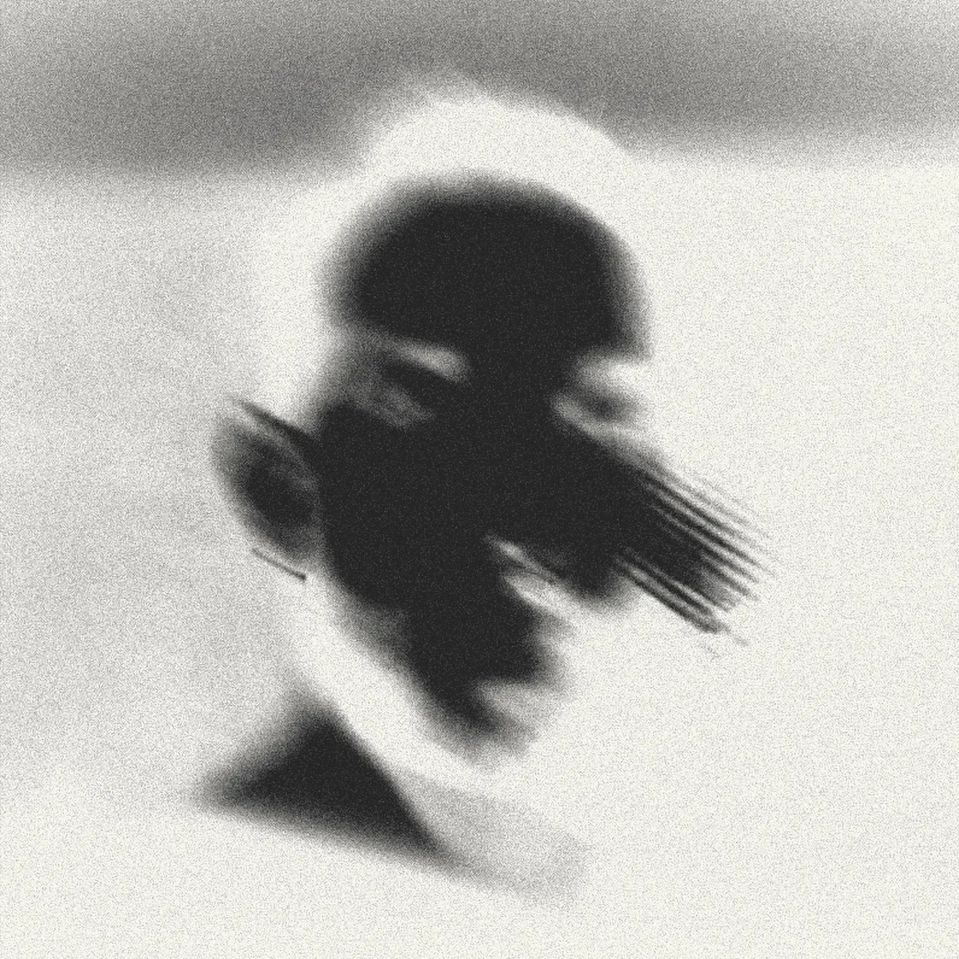 Portrait of Nicolás Navarrete with its tones inverted: a dark figure over a pale background.